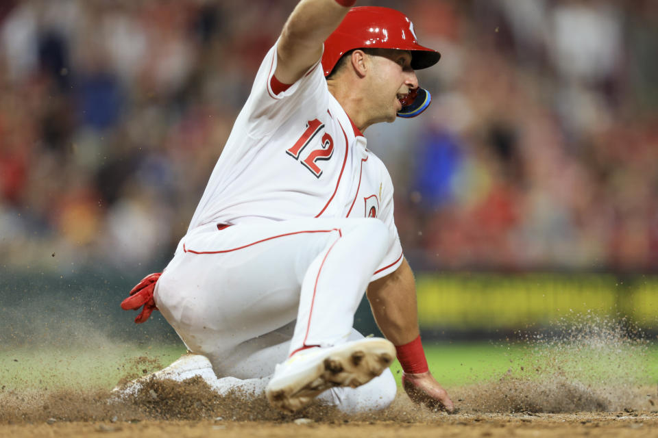 Cincinnati Reds' Spencer Steer scores a run on a walkoff hit by Jonathan India during the ninth inning of a baseball game against the Colorado Rockies in Cincinnati, Friday, Sept. 2, 2022. (AP Photo/Aaron Doster)