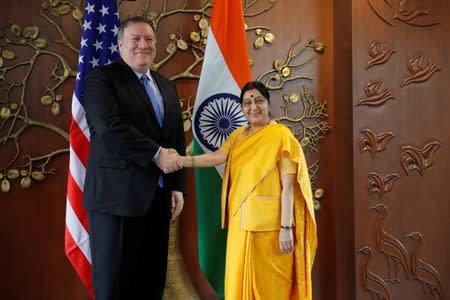 FILE PHOTO: U.S. Secretary of State Mike Pompeo shakes hands with India’s Foreign Minister Sushma Swaraj before the start of their meeting in New Delhi, India