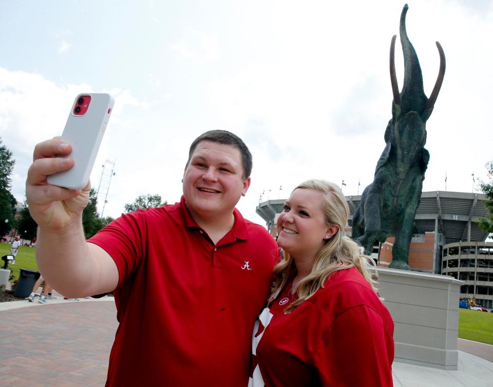 Jake and Courtney Tucker, from Birmingham, take a selfie with Tuska Saturday, Sept. 11, 2021, outside Bryant-Denny Stadium. [Staff Photo/Gary Cosby Jr.]