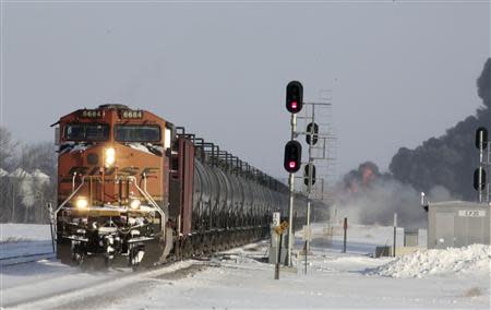 A plume of smoke rises from scene of a derailed train near Casselton, North Dakota December 30, 2013. REUTERS/Michael Vosburg/Forum News Service