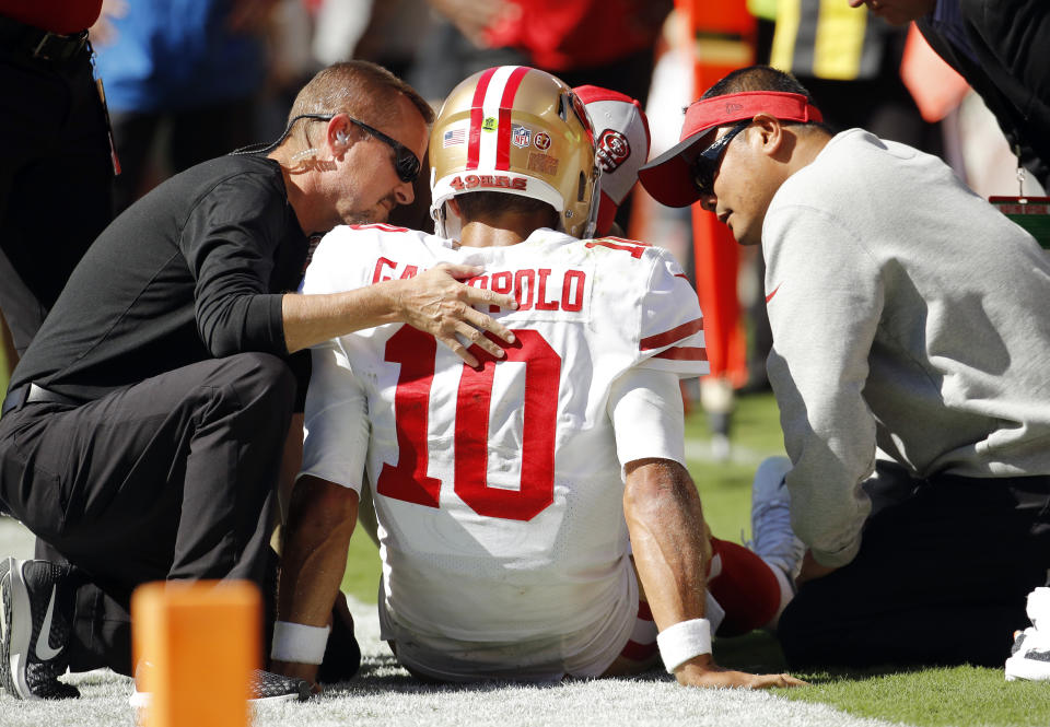 Trainers attend to San Francisco 49ers quarterback Jimmy Garoppolo (10) who was injured after a tackle by Kansas City Chiefs defensive back Steven Nelson during the second half of an NFL football game in Kansas City, Mo., Sunday, Sept. 23, 2018. (AP Photo/Charlie Riedel)