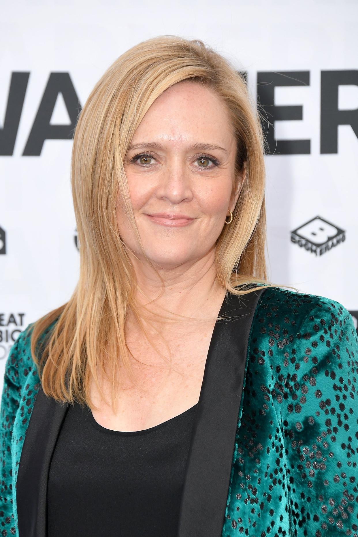 Samantha Bee looks glossy in green suit with black poaches. 