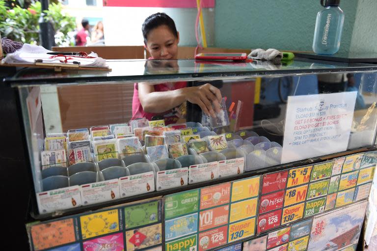 A vendor arranges prepaid phone cards for sale in Singapore on August 14, 2014