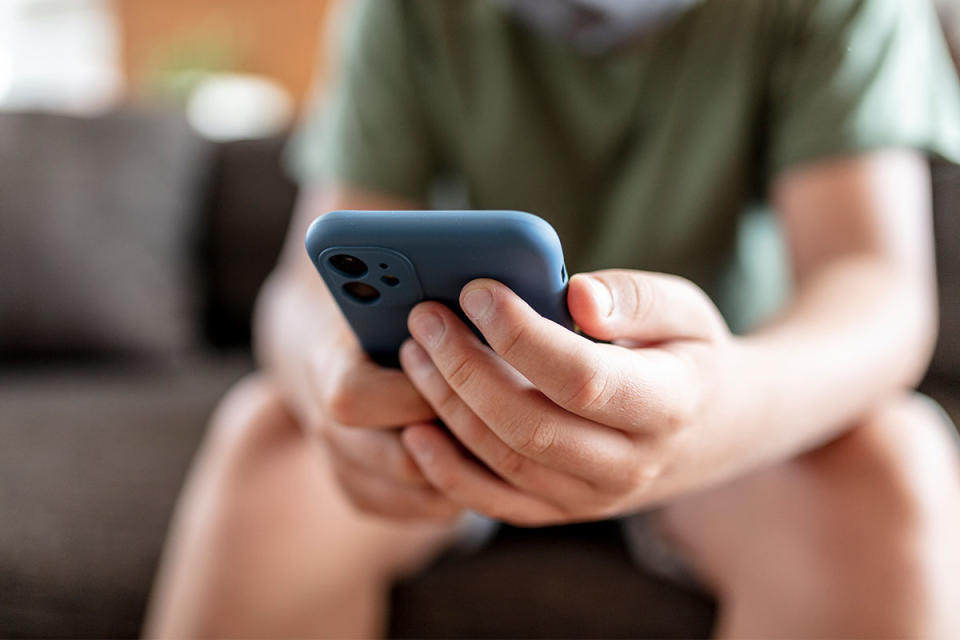 A kid holding a smartphone.