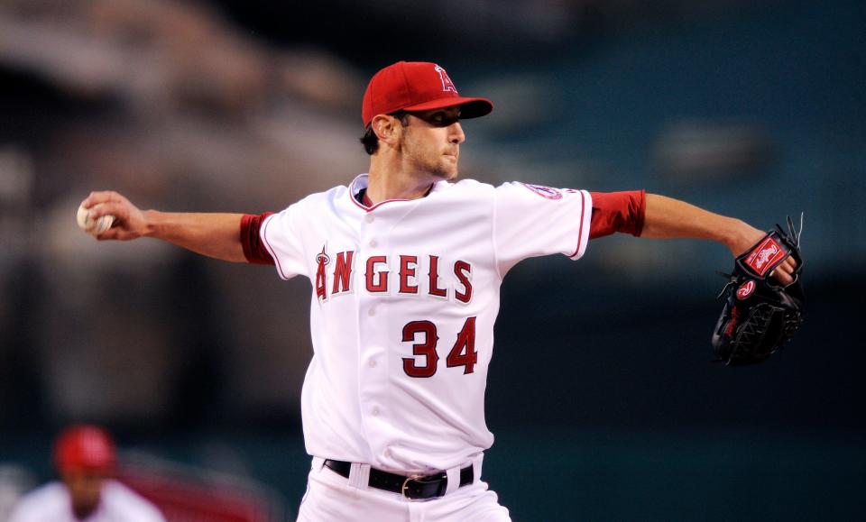 Los Angeles Angels starting pitcher Nick Adenhart throws to first base during the first inning of a game against the Oakland Athletics on April 8, 2009, in Anaheim, Calif.