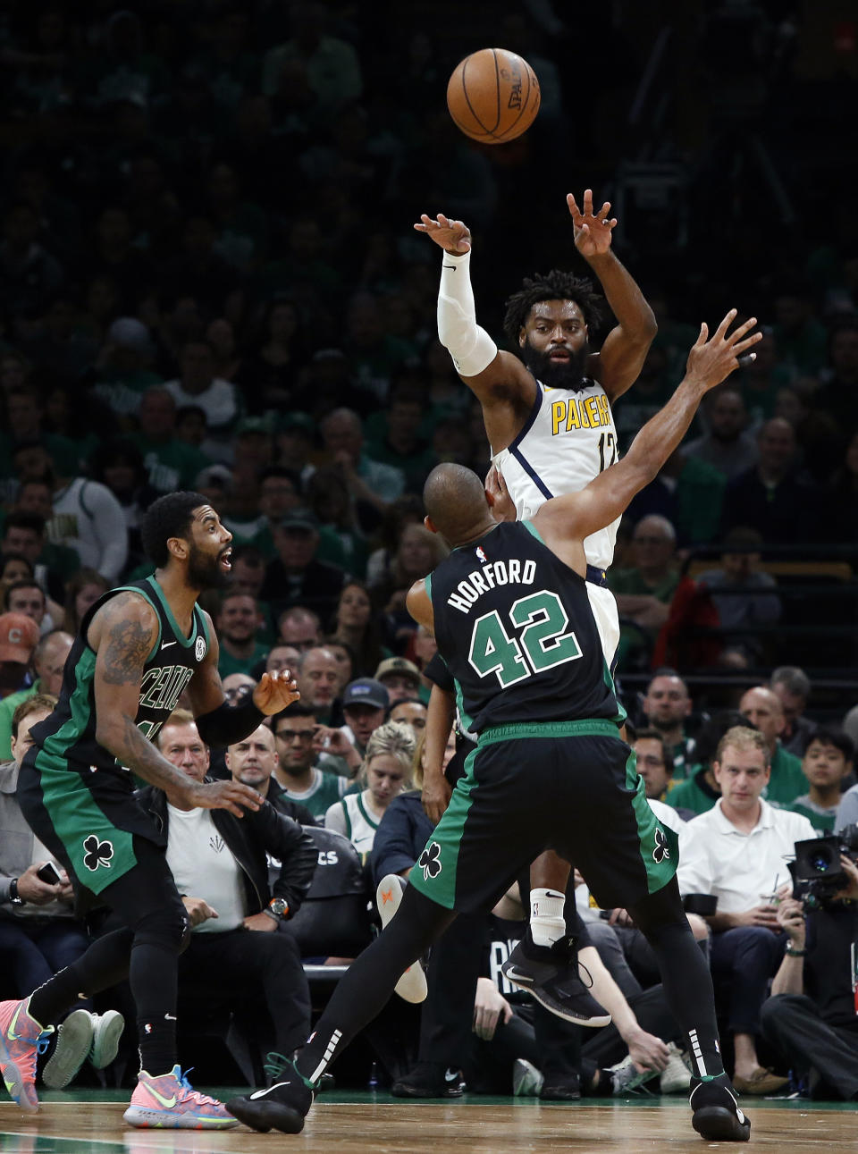 Indiana Pacers' Tyreke Evans throws a pass over Boston Celtics' Al Horford during the second quarter in Game 1 of a first-round NBA basketball playoff series, Sunday, April 14, 2019, in Boston. (AP Photo/Winslow Townson)