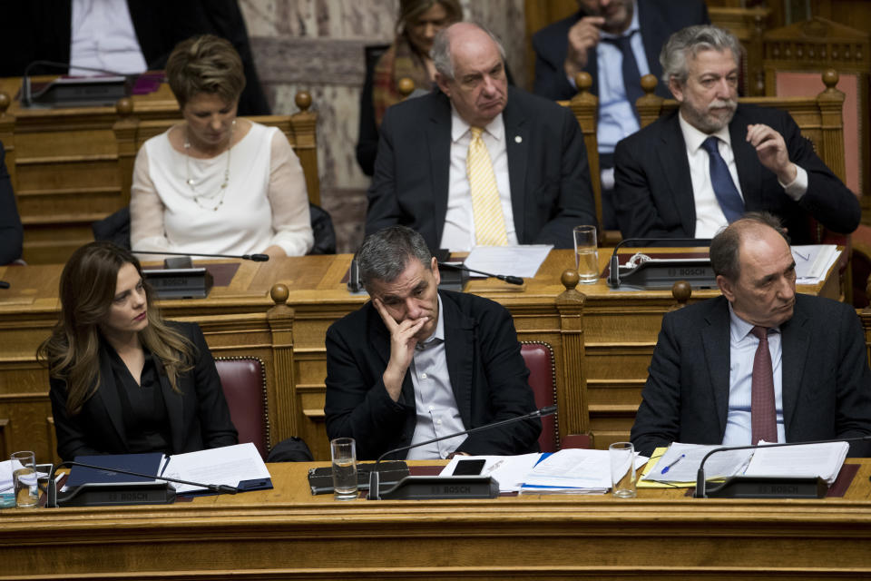 FILE - Greek Labour Minister Effie Achtsioglou, left, Greek Finance Minister Euclid Tsakalotos, center, and Minister of Energy, Giorgos Stathakis, right, attend a Parliament session in Athens, on Monday, Jan. 15, 2018. Achtsioglou, a former Syriza labor minister, led Thursday's Nov. 23, 2023 walkout as nine lawmakers declared themselves independent. They joined the former finance minister Euclid Tsakalotos and another colleague who quit on Nov. 11 – reducing the number of seats held by Syriza in the election from 47 to 36 in the 300-member parliament. (AP Photo/Petros Giannakouris, File)