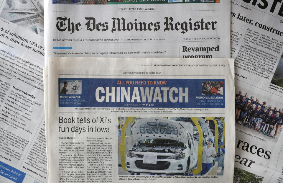 This Friday, Oct. 19, 2018, photo shows a copy of the four-page advertising section Chinawatch along with a copy of The Des Moines Register in Des Moines, Iowa. China's propaganda machine has taken aim at American soybean farmers as part of its high-stakes trade war with the Trump administration. The publication last month of the four-page advertising section in the Register opened a new battle line in China's effort to break the administration's resolve. (AP Photo/Charlie Neibergall)