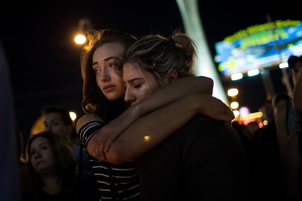 Mourners attend a candlelight vigil at the corner of Sahara Avenue and Las Vegas Boulevard.