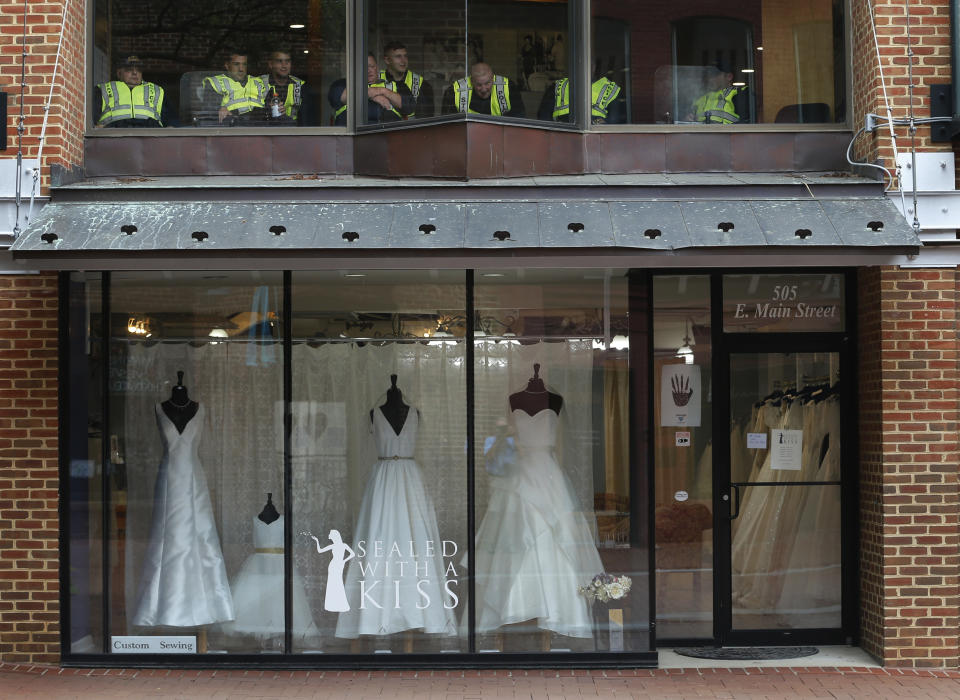 <p>State Police take a break in an office above a closed bridal shop in the downtown area of Charlottesville, Va., Saturday, Aug. 11, 2018. (Photo: Steve Helber/AP) </p>