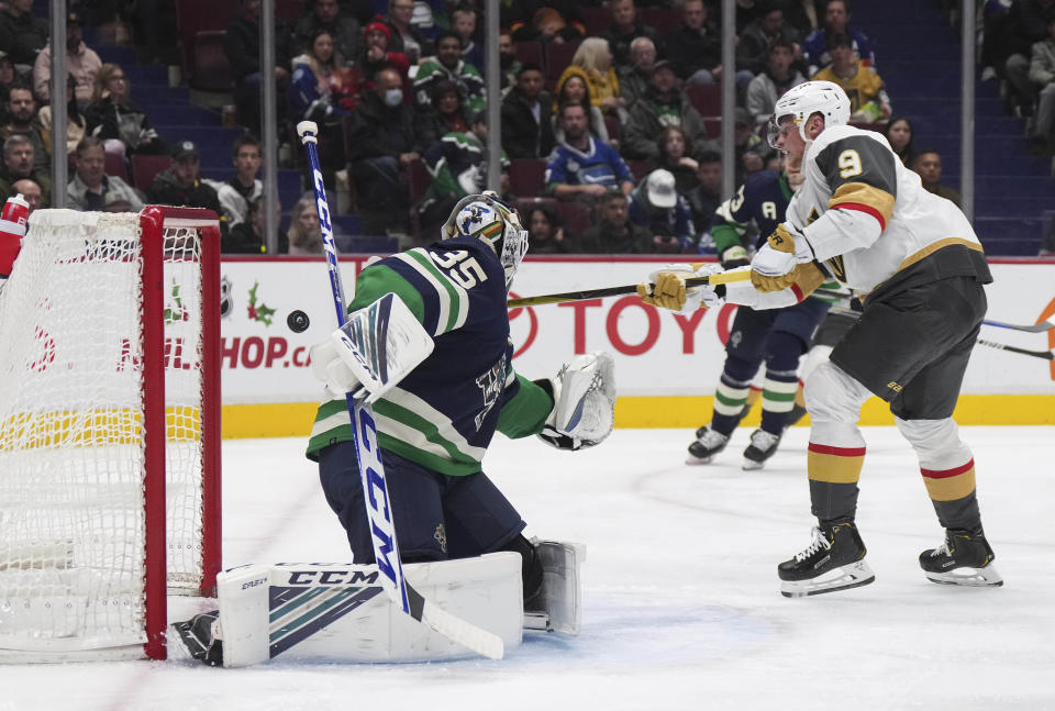 Vegas Golden Knights' Jack Eichel (9) reaches for the puck with his stick but fails to make contact behind Vancouver Canucks goalie Thatcher Demko during the second period of an NHL hockey game in Vancouver, British Columbia, Monday, Nov. 21, 2022. (Darryl Dyck/The Canadian Press via AP)