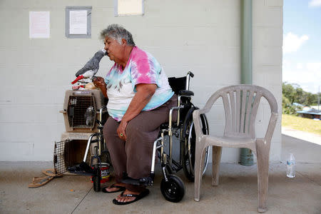 FILE PHOTO: Linda Dee Souza, 72, of Kalapana-Seaview, kisses one of her parrots at a Red Cross evacuation center in Pahoa during ongoing eruptions of the Kilauea Volcano in Hawaii, U.S., May 15, 2018. REUTERS/Terray Sylvester/File Photo