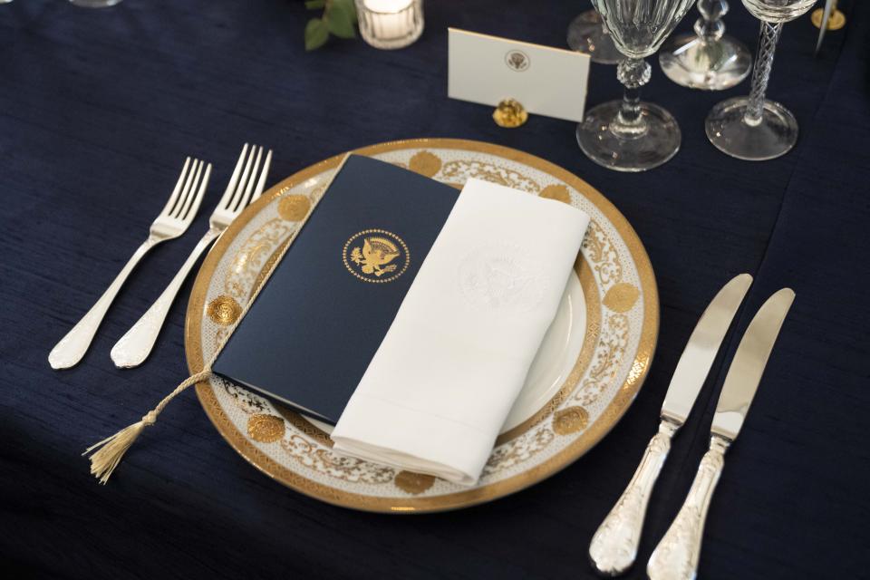 A table is set during a media preview for the State Dinner with President Joe Biden and French President Emmanuel Macron in the State Dining Room of the White House in Washington, Wednesday, Nov. 30, 2022. (AP Photo/Andrew Harnik)