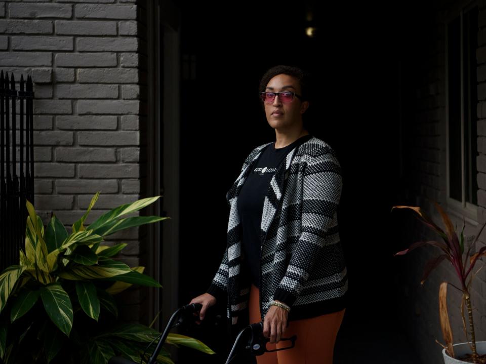 Liza Fisher poses for a portrait outside of her home in Houston. In early July 2020, Liza Fisher of Houston was diagnosed with COVID pneumonia and by the end of the month, she was in a hospital intensive care unit. A week later, she was transferred to a rehab facility where she stayed, other than another two-week hospital stint, until Oct. 13, 2020.  In rehab she lost the ability to walk and began suffering debilitating tremors, for reasons her doctors still don't understand. Now, more than two years after her initial infection, Fisher is making slow, incremental progress and hoping for no more setbacks.