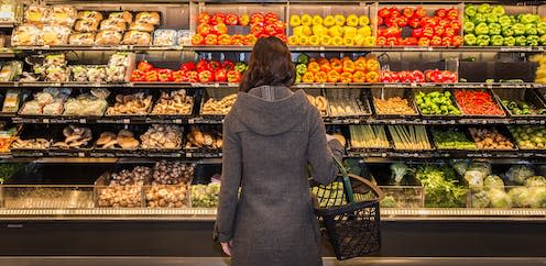 <span class="caption">Supermarkets are beginning to remove date labels on fruit and veg to tackle the food waste issue.</span> <span class="attribution"><a class="link " href="https://www.shutterstock.com/image-photo/woman-standing-front-row-produce-grocery-358499339" rel="nofollow noopener" target="_blank" data-ylk="slk:Adam Melnyk/Shutterstock;elm:context_link;itc:0;sec:content-canvas">Adam Melnyk/Shutterstock</a></span>