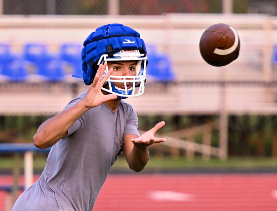 MASHPEE 8/21/23 Mashpee receiver Makai Hue takes in a pass during practice.