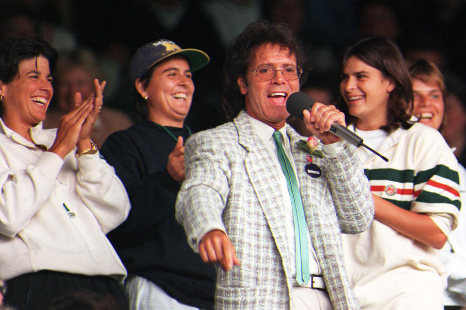 Sir Cliff Richard entertains the Centre Court crowd at Wimbledon after rain stopped play in 1996.