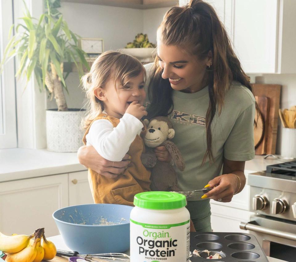 PHOTO: Alex Morgan with her daughter Charlie baking protein snacks in the kitchen. (Mullen Lowe)