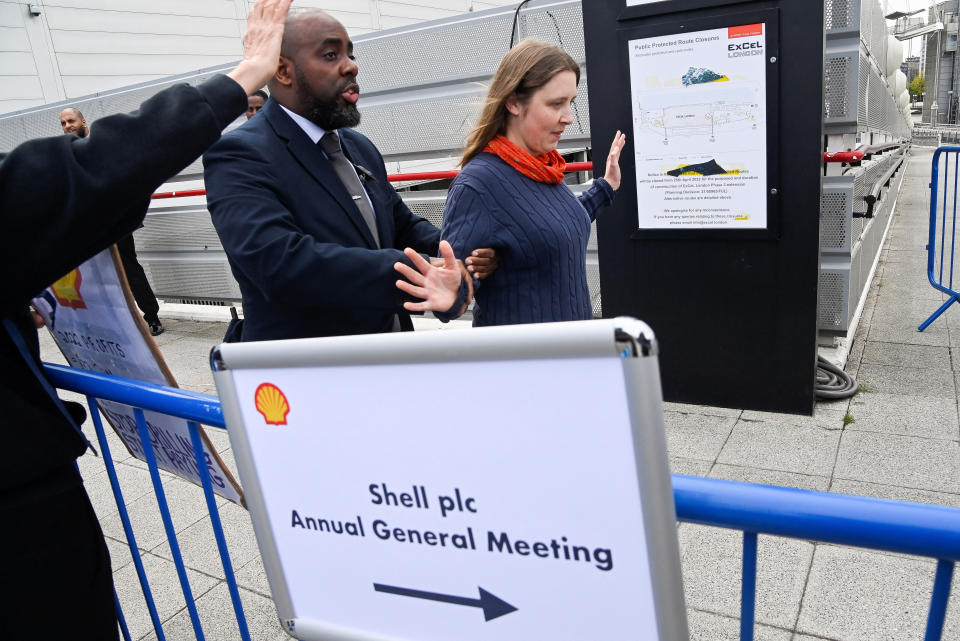 Security personnel remove a protester during the Fossil Free London demonstration outside the venue of Shell's annual shareholder meeting, at the ExCeL center, in London, Britain May 23, 2023. REUTERS/Toby Melville