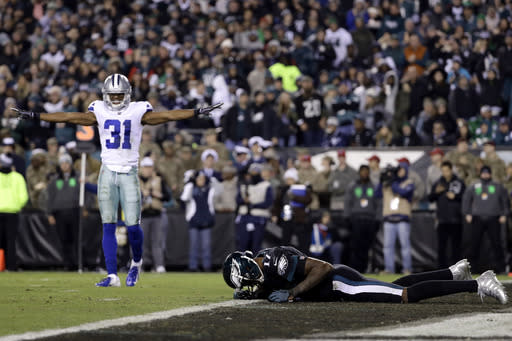 Philadelphia Eagles wide receiver Alshon Jeffery, right, lies on the ground after missing a catch as Dallas Cowboys cornerback Byron Jones (31) reacts to the play during the second half of an NFL football game, Sunday, Nov. 11, 2018, in Philadelphia. (AP Photo/Matt Slocum)