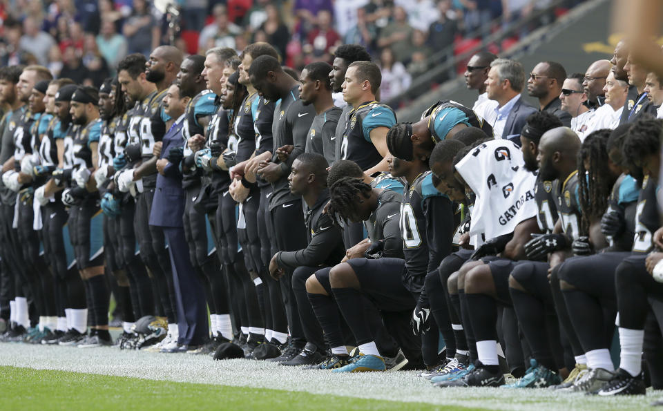 Jaguars players lock arms and kneel in September days after President Donald Trump blasted the NFL. (AP) 