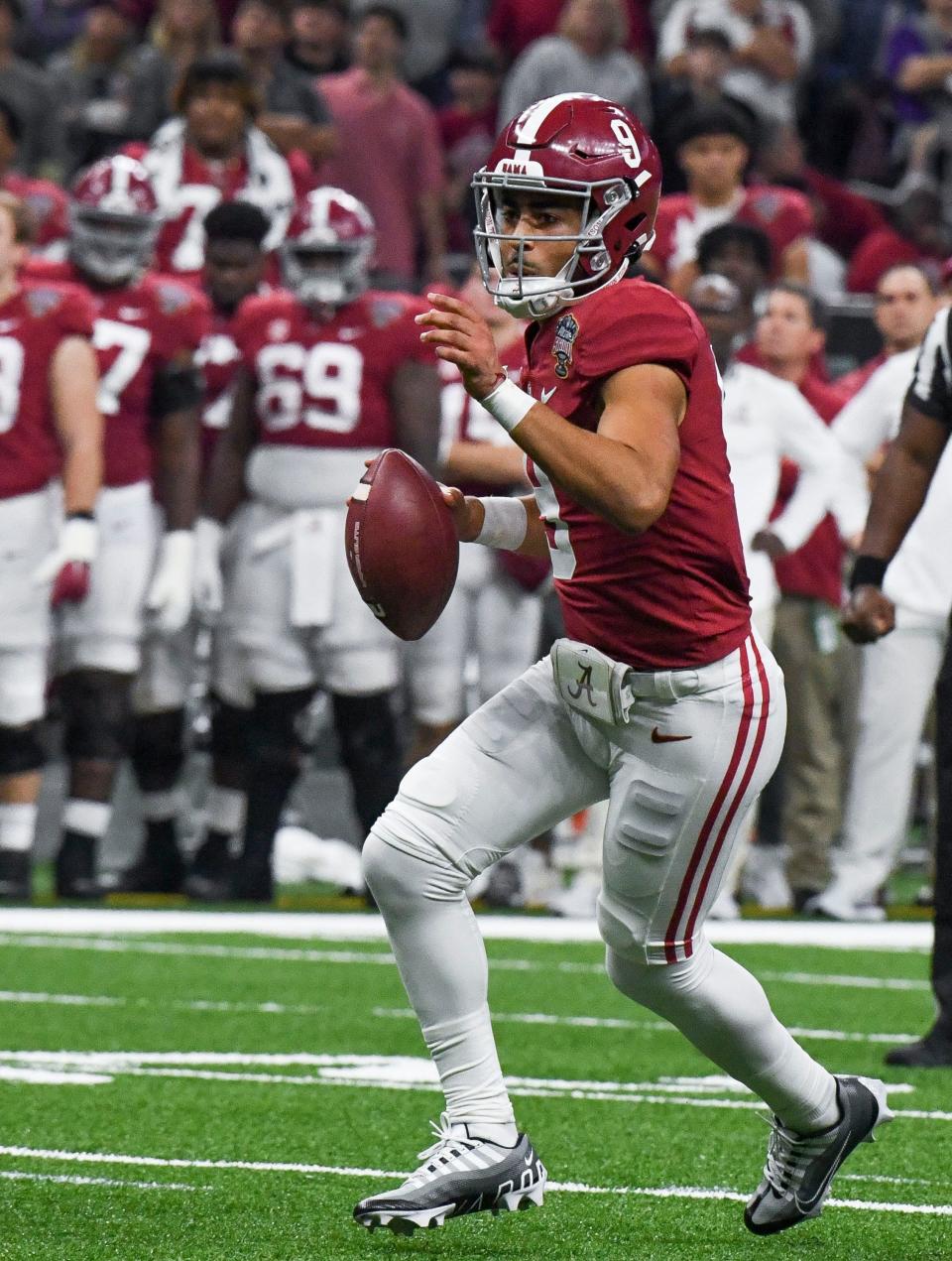 Alabama quarterback Bryce Young directs receivers as he runs a play against Kansas State during the Sugar Bowl at Caesars Superdome, Dec. 31, 2022 in New Orleans.