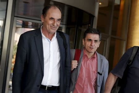 Greek Economy Minister George Stathakis (L) and Finance Minister Euclid Tsakalotos leave a hotel following an overnight meeting with representatives of the International Monetary Fund, the European Commission, the European Central Bank and the eurozone's rescue fund, the European Stability Mechanism in Athens, August 11, 2015. REUTERS/Alkis Konstantinidis