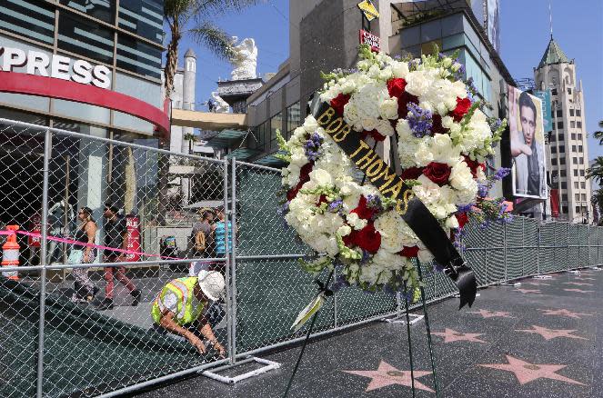 Flowers are next to the star of Associated Press entertainment reporter Bob Thomas on Hollywood's Walk of Fame in Los Angeles Friday, Mar. 14, 2014. Bob Thomas died Friday at his Encino, Calif., home at age 92. He is listed twice in Guinness World Records: for most consecutive Academy Awards shows covered by an entertainment reporter and for longest career as an entertainment reporter (1944-2010). In 1988, he became the first reporter-author awarded a star on Hollywood's Walk of Fame. (AP Photo/Damian Dovarganes)