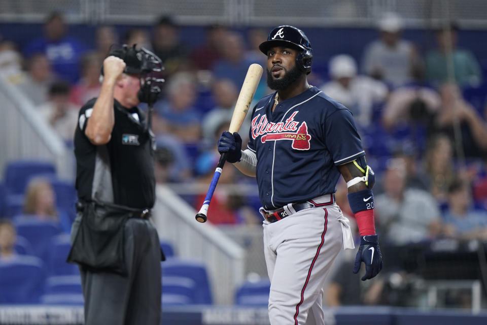 Atlanta Braves' Marcell Ozuna reacts after striking out during the seventh inning of a baseball game against the Miami Marlins, Sunday, Aug. 14, 2022, in Miami. (AP Photo/Wilfredo Lee)