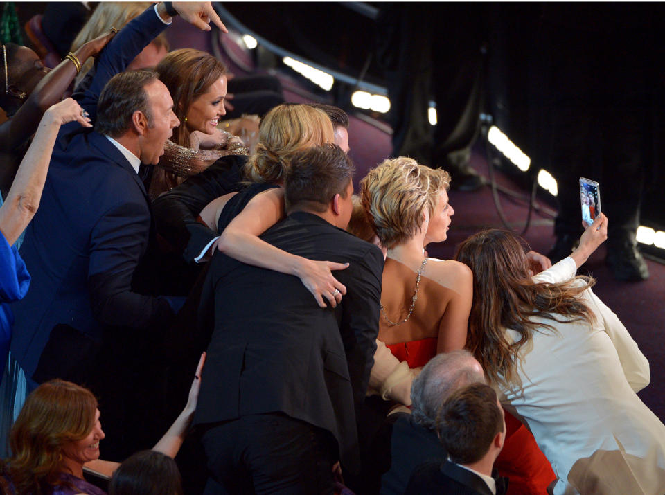 Kevin Spacey, from left, Angelina Jolie, Julia Roberts, Brad Pitt, Jennifer Lawrence, Ellen Degeneres and Jared Leto join other celebrities for a "selfie" during the Oscars at the Dolby Theatre on Sunday, March 2, 2014, in Los Angeles. (Photo by John Shearer/Invision/AP)