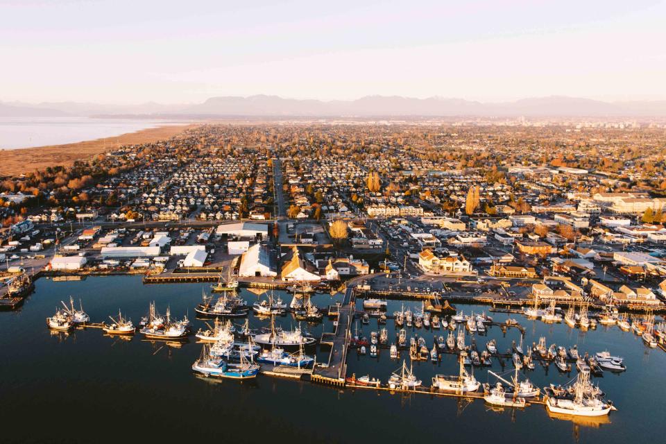 <p>Tourism Richmond</p> Richmond sits on an island in the Fraser River south of Vancouver; the North Shore Mountains are visible in the distance