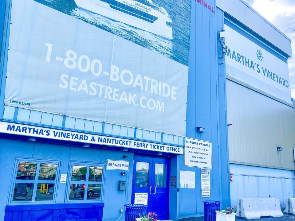 Martha's Vineyard ferry terminal, which is a blue building with dark-blue doors and a light-blue sign that says "1-800-BOATRIDE" in white lettering