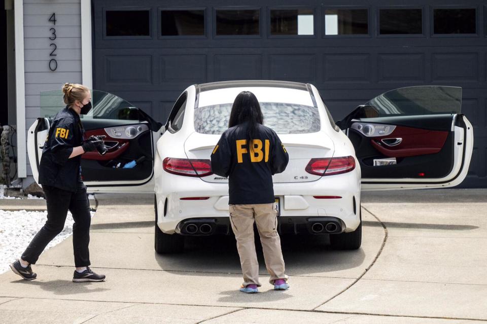 FBI personnel work on an investigation at a home in Oakland.