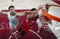 Japan' Yuta Watanabe (12) scores past Slovenia's Mike Tobey (10) during a men's basketball game at the 2020 Summer Olympics, Thursday, July 29, 2021, in Saitama, Japan. (AP Photo/Eric Gay)