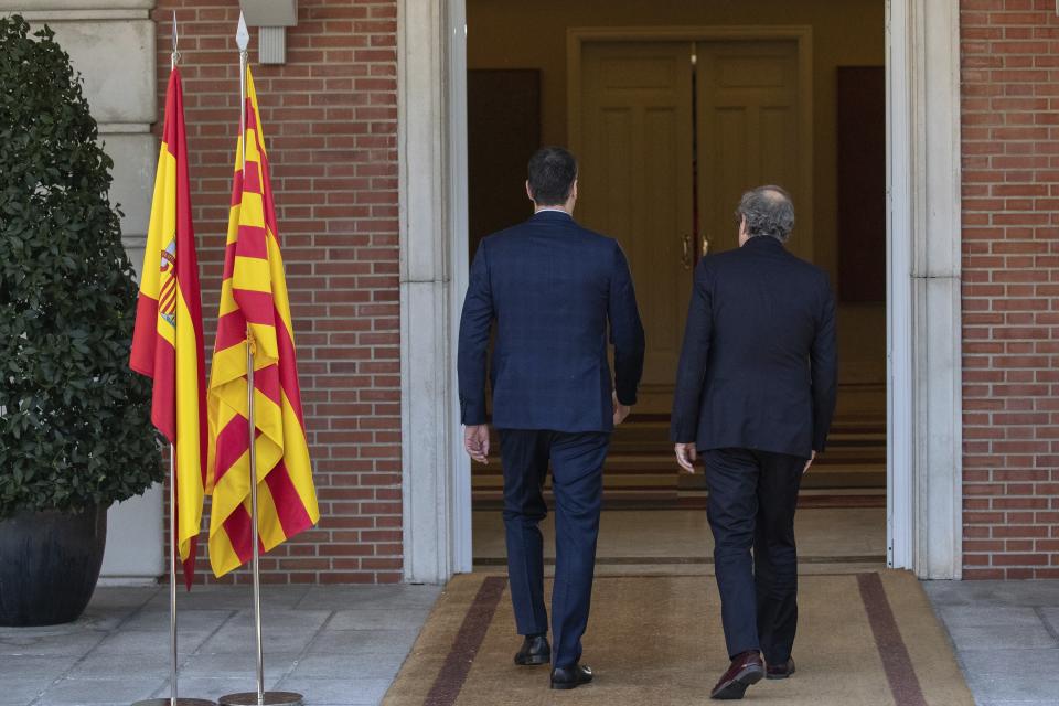 Spanish Prime Minister Pedro Sanchez, left, and Catalan regional President Quim Torra walk into a meeting at the Moncloa palace in Madrid, Spain, Wednesday, Feb. 26, 2020. Spain's prime minister and the leader of Catalonia are opening formal talks Wednesday in hopes of resolving the festering political crisis provoked by the region's separatist movement. (AP Photo/Bernat Armangue)