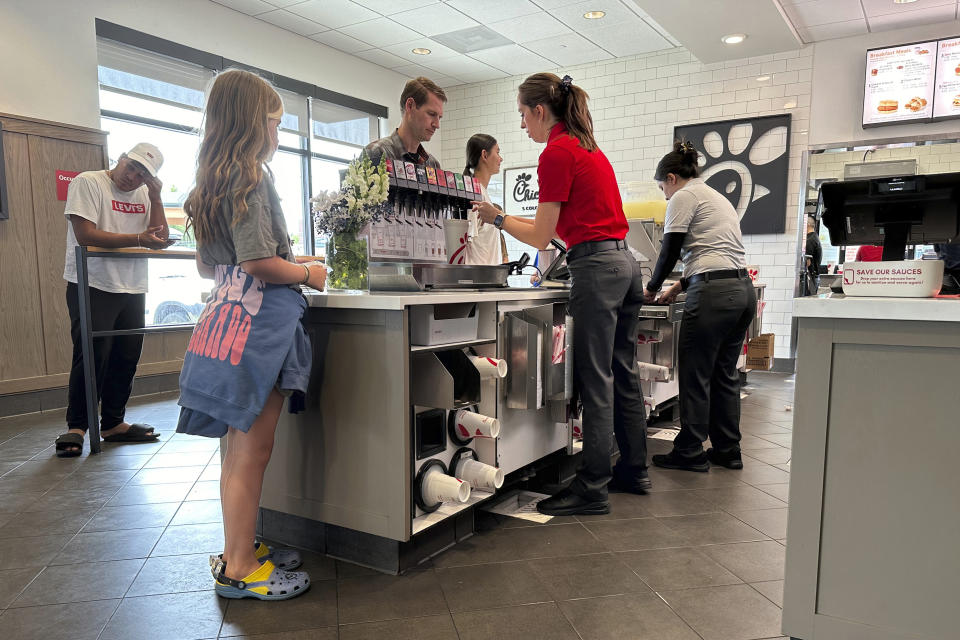 Workers serve customers at a fast food restaurant Thursday, June 27, 2024, in southeast Denver. On Thursday, July 11, 2024, the Labor Department issues its report on inflation at the consumer level in June. (AP Photo/David Zalubowski)