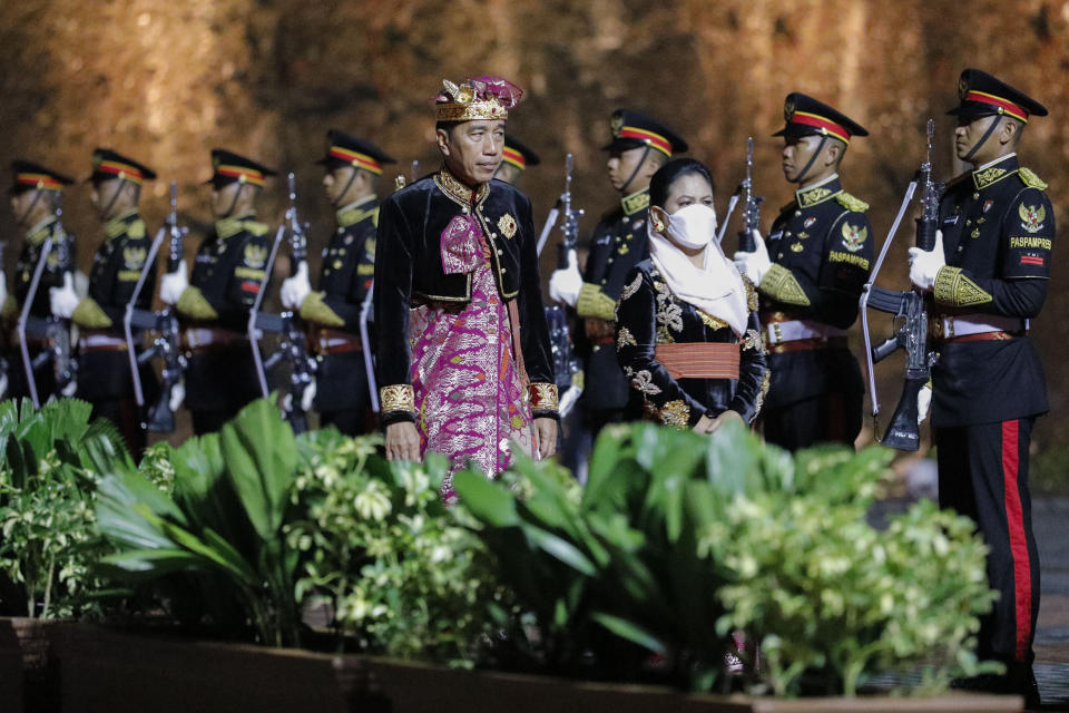 Indonesian President Joko Widodo and his wife Iriana review the honor guard at the Welcoming Dinner during G20 Leaders' Summit at the Garuda Wisnu Kencana Cultural Park, in Badung, Bali, Indonesia, on Tuesday, Nov. 15, 2022. (Willy Kurniawan/Pool Photo via AP)