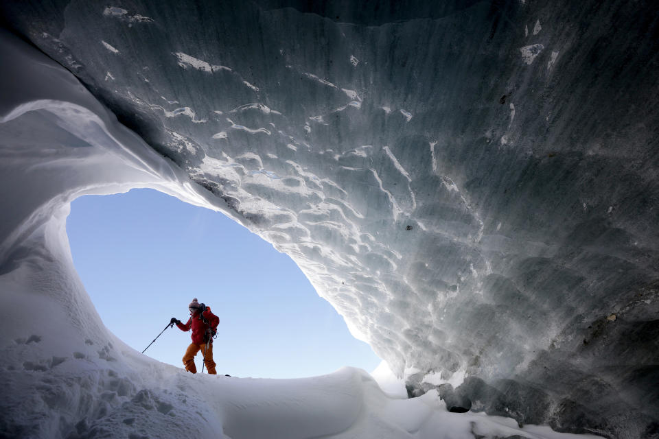 Glaciologist Andrea Fischer from the Austrian Institute for Interdisciplinary Mountain Research, walks at the entrance of an ice cave of Jamtalferner glacier near Galtuer, Austria. (Photo: Lisi Niesner/Reuters)