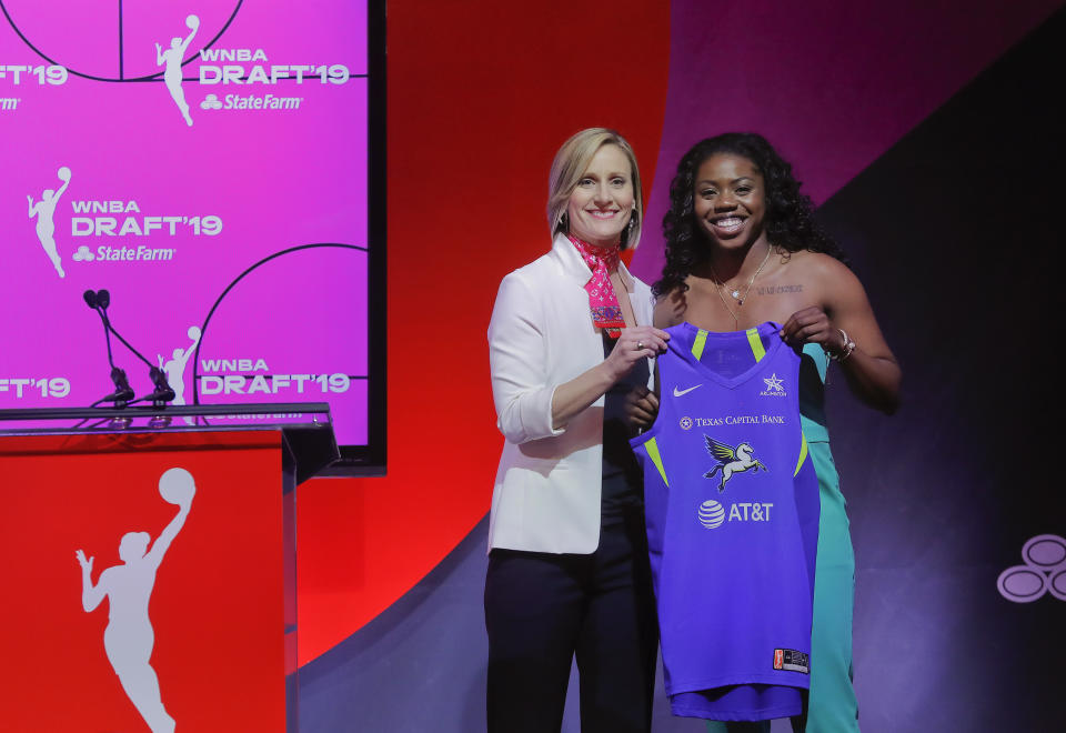 Notre Dame's Arike Ogunbowale, right, poses for a photo with WNBA COO Christy Hedgpeth after being selected by the Dallas Wings as the fifth overall pick in the WNBA basketball draft Wednesday, April 10, 2019, in New York. (AP Photo/Julie Jacobson)