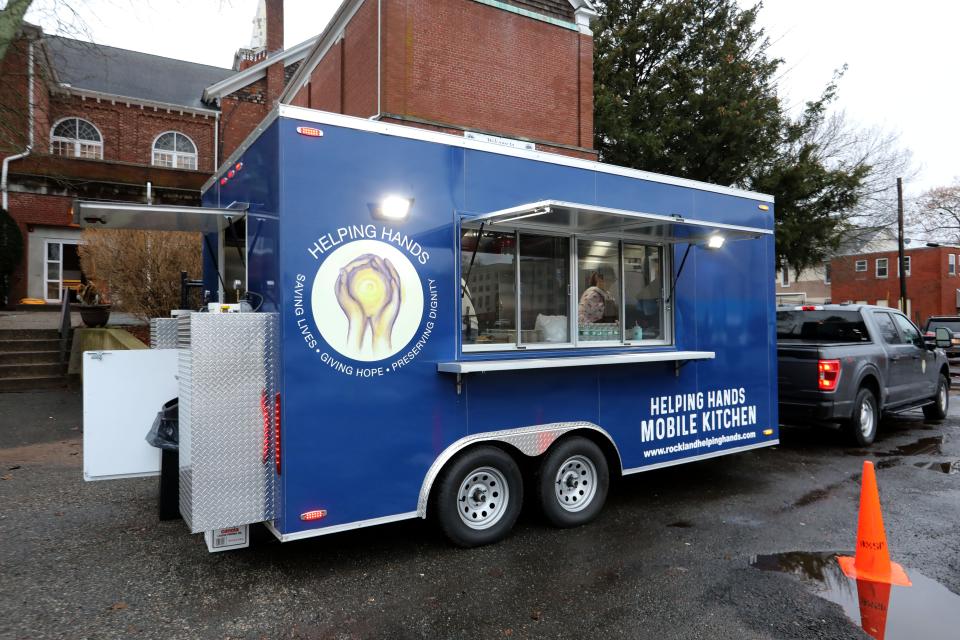 Volunteers and staff of the new Helping Hands For the Homeless of Rockland food truck prepare meals while parked in Memorial Park in Spring Valley Dec. 28, 2023.