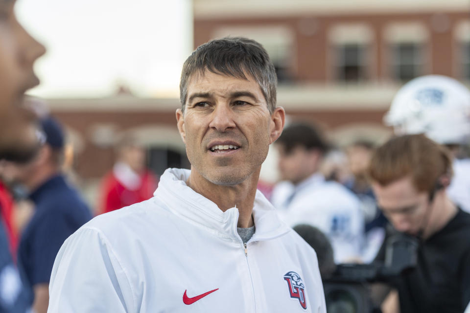 Liberty's Jamey Chadwell looks to greet players after an NCAA college football game against Old Dominion, Saturday, Nov. 11, 2023, in Lynchburg, Va. (AP Photo/Robert Simmons)