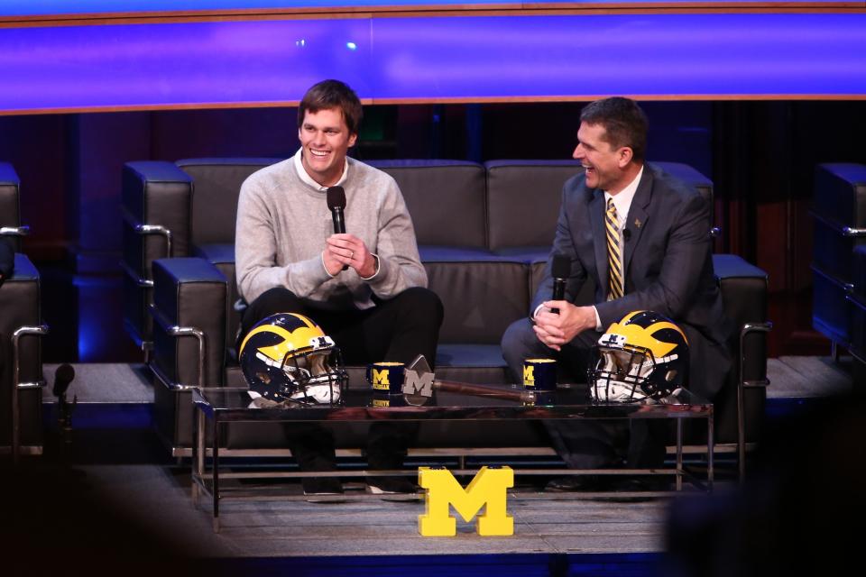 Tom Brady and Jim Harbaugh at Michigan's signing event (Getty). 