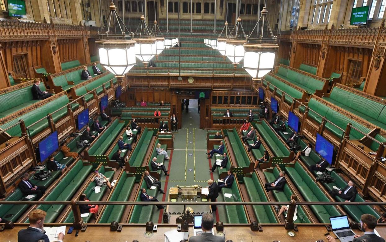 A handout photograph released by the UK Parliament on December 22, 2020, as part of a package to show how Britain's Parliament responded to the Coronavirus Covid-19 pandemic, shows the social distancing measures installed in the Press Gallery during Prime Minister's Questions (PMQs), in a socially distanced and hybrid session of the House of Commons, in central London on July 22, 2020. - British MPs returned to parliament on June 2, 2020 as the virtual system introduced during the coronavirus lockdown ended. MPs have attended the House of Commons either physically or by video call since late April but the government announced last month that business would now be conducted in person. (Photo by JESSICA TAYLOR / UK PARLIAMENT / AFP) / RESTRICTED TO EDITORIAL USE - MANDATORY CREDIT " AFP PHOTO / JESSICA TAYLOR / UK PARLIAMENT " - NO USE FOR ENTERTAINMENT, SATIRICAL, MARKETING OR ADVERTISING CAMPAIGNS - EDITORS NOTE THE IMAGE MAY HAVE BEEN DIGITALLY ALTERED AT SOURCE TO OBSCURE VISIBLE DOCUMENTS  - JESSICA TAYLOR/AFP via Getty Images