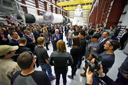 U.S. Vice President Mike Pence talks with SpaceX employees during a tour of the SpaceX hangar at Launch Complex 39-A, where the Dragon crew module and Falcon 9 booster rocket are being prepared for a January 2019 launch at Cape Canaveral, Florida, U.S. December 18, 2018. REUTERS/Steve Nesius