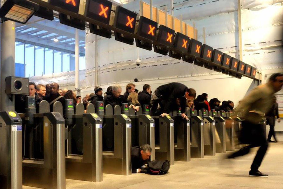 Chaos: Passengers scramble over barriers during disruption at London Bridge (Picture: @BlowersSon/Twitter)