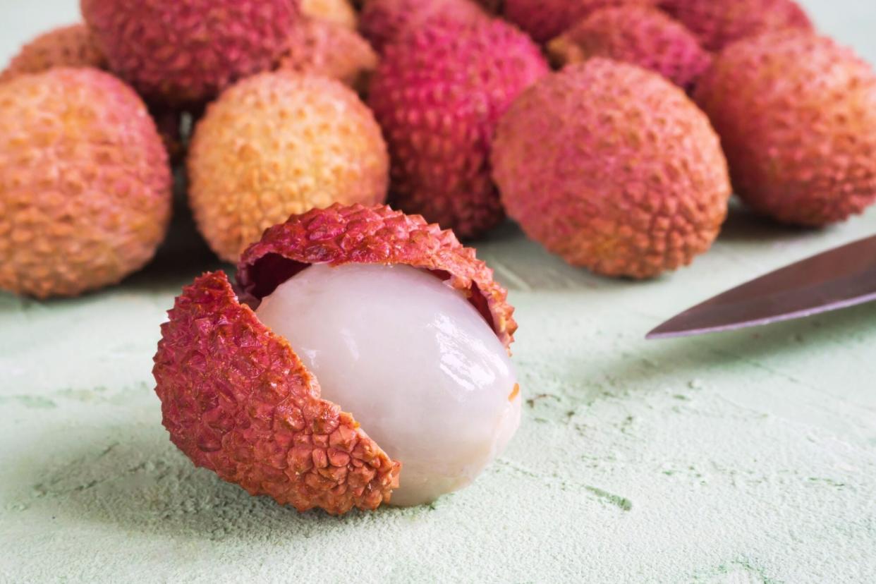 peeled lychee next to pile on table