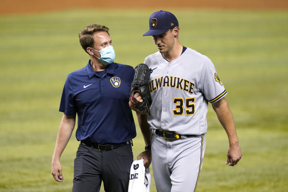 Milwaukee Brewers starting pitcher Brent Suter (35) leaves a baseball game during the third inning against the Miami Marlins, Friday, May 7, 2021, in Miami. (AP Photo/Lynne Sladky)