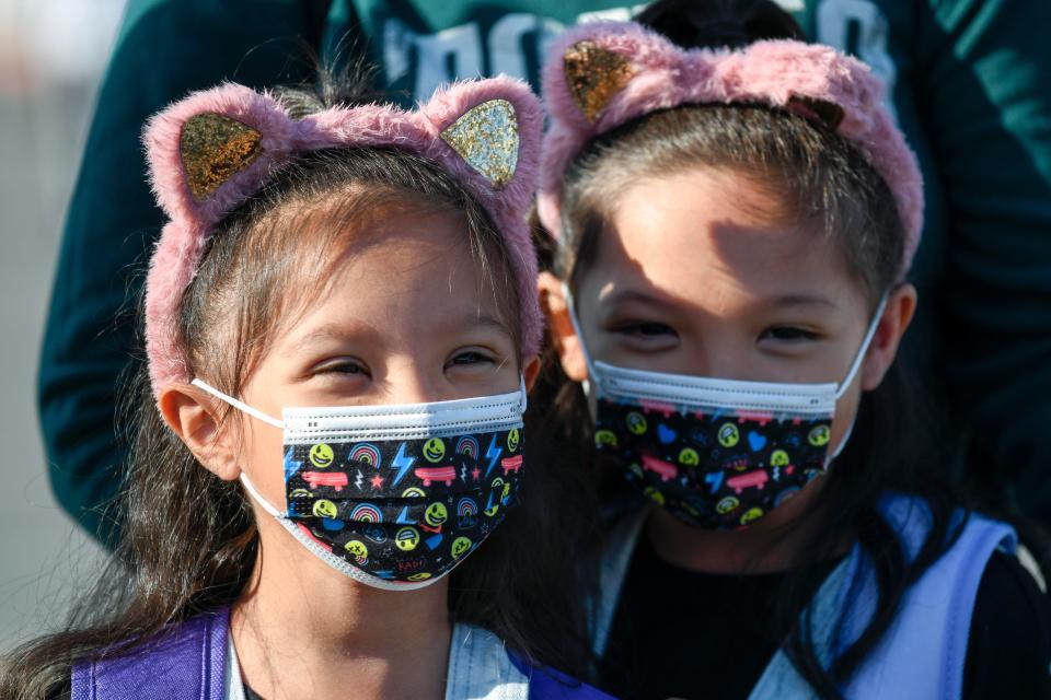 Students wait to go to their classrooms on the first day at Enrique S. Camarena Elementary School on Wednesday in Chula Vista, Calif. The school was among the first in the state to start the 2021-22 school year with full-day, in-person learning.