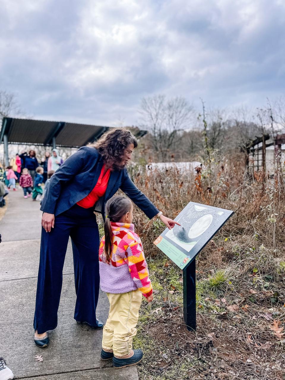 Mayor Indya Kincannon reads pages along the Public Library Storybook trail at Ijams Nature Center features “Run Wild” by David Covell, a story celebrating nature and a carefree spirit. Nov. 30, 2022.