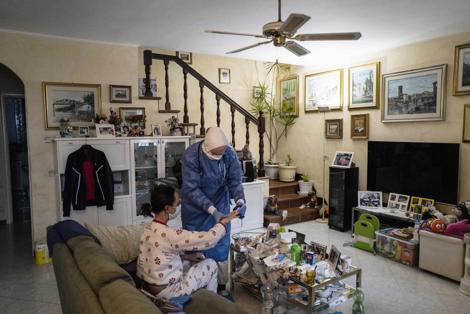 During a house visit, like this one on March 26, Cavanna will wear a disposable gown over his protective suit as well as googles, two masks, two gloves, two caps and shoe covers. | Gabriele Micalizzi—Cesura